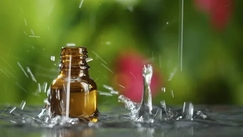 Drops falling into bottle in water close-up, raining. Freshness concept. Nature Stock Footage 167044669