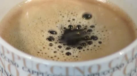 Drops falling into a cup of coffee Stock Footage 24672364