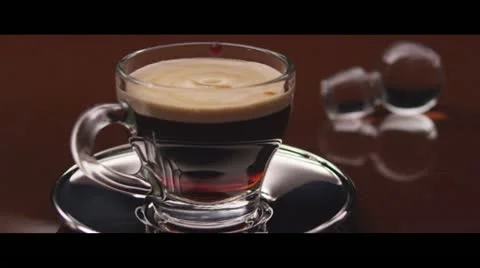 Drops falling into a cup of espresso Stock Footage 24672043