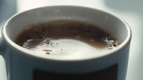Drops falling in a cup of espresso in slow motion. Stock Footage 97236259