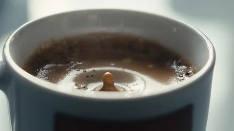 Drops falling in a cup of espresso in slow motion. Stock Footage 97236266