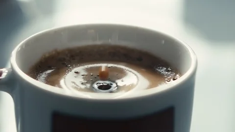 Drops falling in a cup of espresso in slow motion. Stock Footage 97236276