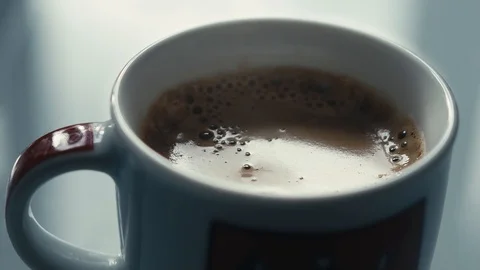Drops falling in a cup of espresso in slow motion. Stock Footage 97236285