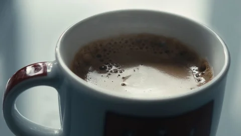 Drops falling in a cup of espresso in slow motion. Stock Footage 97236307