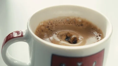 Drops falling in a cup of espresso in slow motion. Stock Footage 97236322