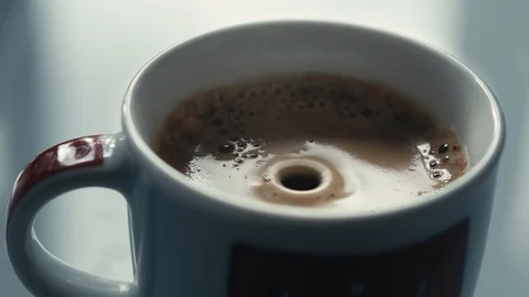 Drops falling in a cup of espresso in slow motion. Stock Footage 97236323