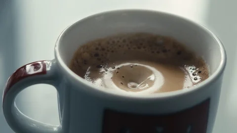Drops falling in a cup of espresso in slow motion. Stock Footage 97236331