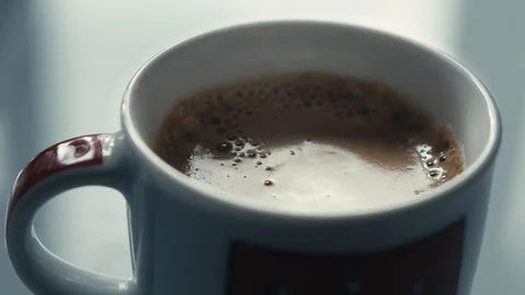 Drops falling in a cup of espresso in slow motion. Stock Footage 97236339