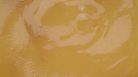 Drops falling onto the surface of homemade bone broth and waves forming Video stock 171833497