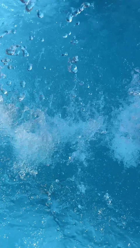 Drops falling on the water in swimming pool, vertical video Stock Footage 282766104