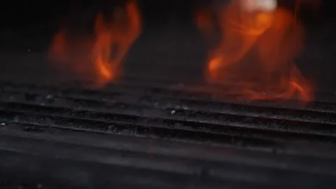 Drops of fat dripping onto the grill and burning, slow motion Stock Footage 210250293