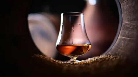 Drops flow down a glass of bourbon whiskey Video stock 269022006