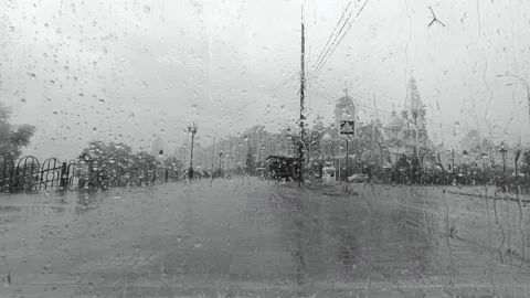 Drops flow down the glass in the rain against the background of the embankment Stock Footage 138300827