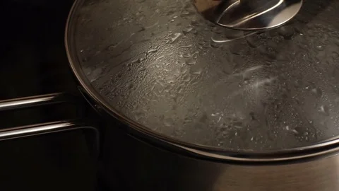 Drops flow down the lid of the saucepan. Video Stock Footage 85330970
