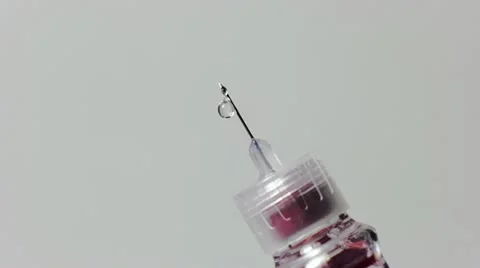 Drops follow from a needle Vídeos de archivo 12441924