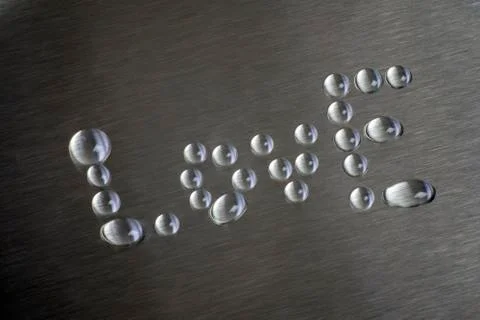 Drops in the form of words like. The surface is metallic Stock Photos