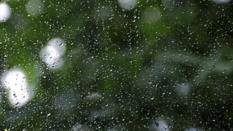 Drops on the glass . Drops trickle down the glass. The rain outside the window Stock Footage 142287931