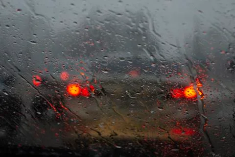 Drops on glass, machine blurred. Blurred silhouette of the car through the gl Stock Photos