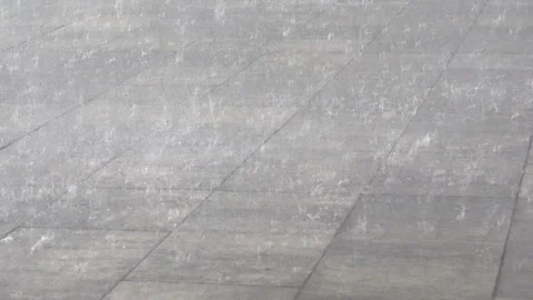 Drops of heavy rain fall on road Stock Footage 197015124