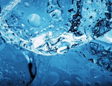 Drops on an ice cube shot close-up Stock Photos