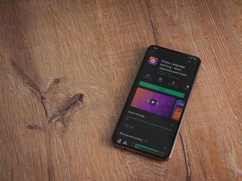 Drops - Language learning app play store page on the display of a black mobil Stock Photos