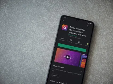 Drops - Language learning app play store page on the display of a black mobil Stock Photos