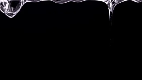 Drops of liquid flow down from the surface. Gel on a black Stock Footage 168647552