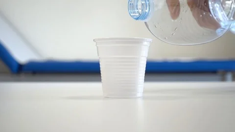 Drops of medicine put into a plastic cup Stock Footage 102672393