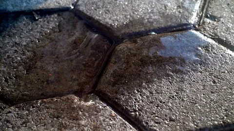 Drops of melted snow fall on the paving stones Stock Footage 123688457