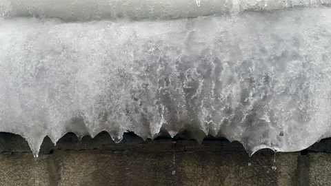 Drops of melting snow flow down Stockbeeldmateriaal 230915634