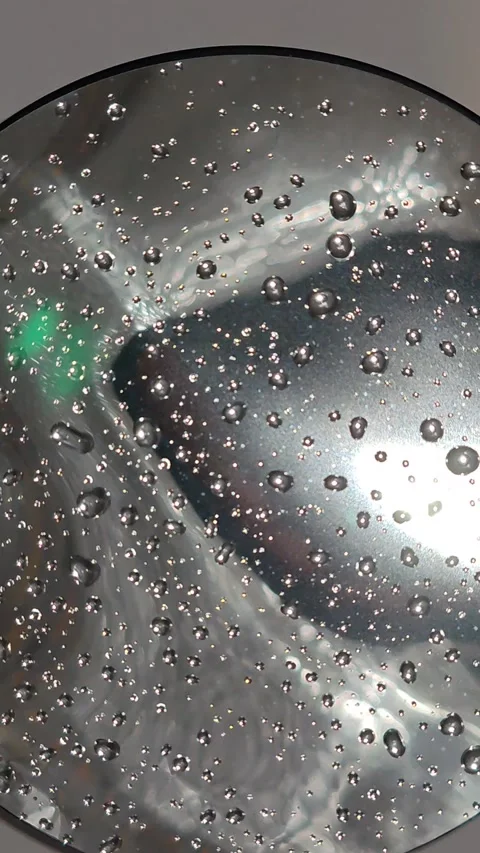 The drops moving in a circle are mesmerizing, the large refraction of light is v Stock Footage 325050849