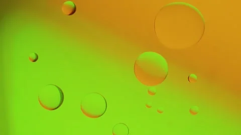 Drops moving on a yellow-green gradient background. 動画素材 303058853