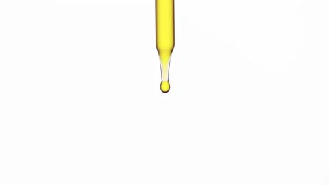 Drops of olive oil are falling down from lab dropper Stock Footage 167650104