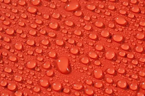Drops on orange background Stock Photos
