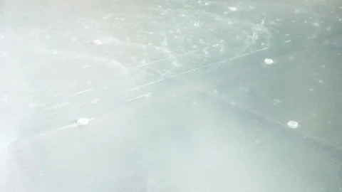 Drops of pouring rain fall into puddles on the sidewalk. close-up. Slow motion Stock Footage 91892932