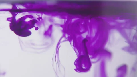 Drops of purlple ink falling and flowing in water. Stock Footage 273124180