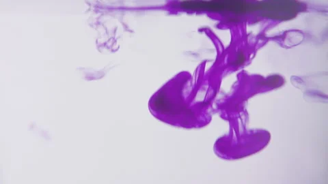 Drops of purlple ink falling and flowing in water. Stock Footage 273124376