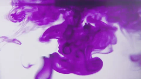 Drops of purlple ink falling and flowing in water. Stock Footage 273124388