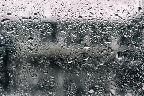 Drops of rain on a dark background, drops after rain on a glass. Stock Photos