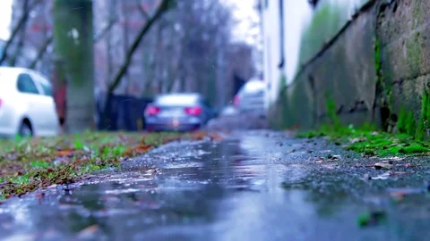 Drops of rain fall on the asphalt. Snow is melting, spring is coming close-up Stock-Footage 125000215