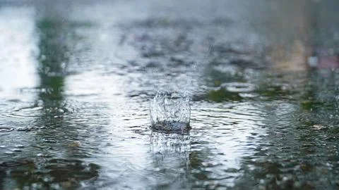 Drops of rain that fall on the asphalt when it rains. close-up rain drops. .. Stock Photos