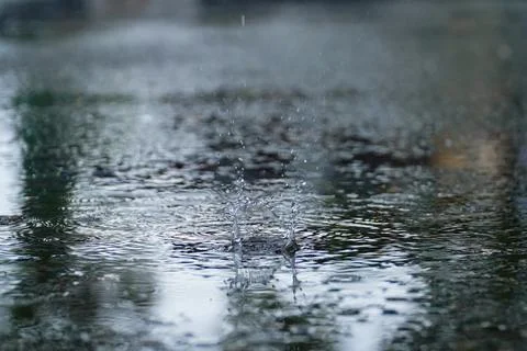 Drops of rain that fall on the asphalt when it rains. close-up rain drops. .. Stock Photos