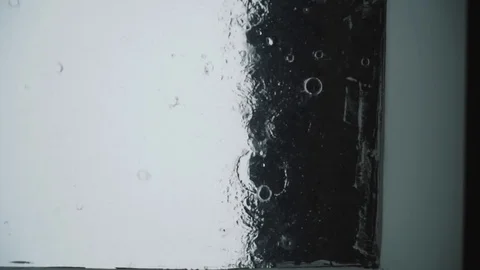 Drops of rain fall on the glass. spray tropical rain 库存影片 102375758