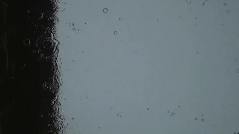 Drops of rain fall on the glass. spray tropical rain Stock Footage 102375786