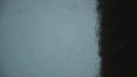 Drops of rain fall on the glass. spray tropical rain Stock Footage 102375798