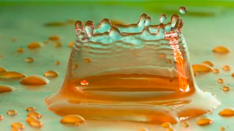 Drops of rain fall into the water, selective focus close-up Stock Photos