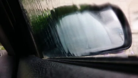 Drops of rain flow down the glass of the car Stock Footage 91938619