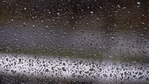 Drops of Rain Flow Down the Glass Against the Backdrop of Moving Cars Stock Footage 255511048