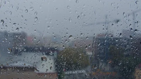 Drops of rain flow down the windowpane in cloudy weather Stock Footage 165052546