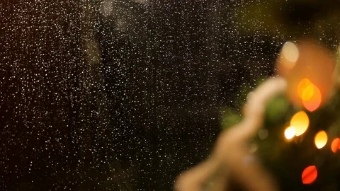 Drops of rain on New Year window glass on the background of the Christmas toys. Stock Footage 70739290